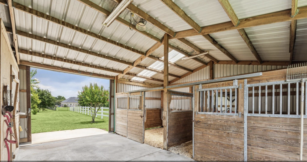 A spread of almost four acres at 2403 San Miguel in Friendswood is large enough for a double stall horse barn and room for riding. (Photo by TK Images for Compass)